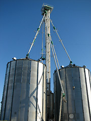 Image showing Steel grain bins and blue sky