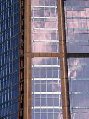 Image showing Glass-windowed corporate building reflecting the sky