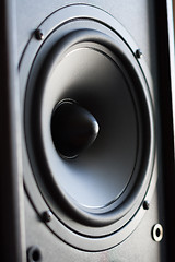 Image showing Powerful audio system. Closeup view of black bass power speaker