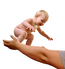 Image showing toddler boy smiling in mom's hands