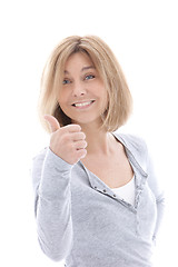 Image showing Happy casual woman giving a thumbs up