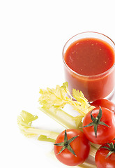 Image showing Glass of tomato juice and tomatoes on a white background