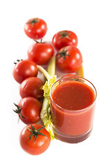 Image showing Glass of tomato juice and tomatoes