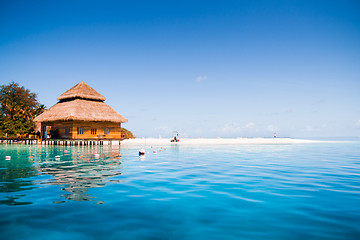Image showing Over water bungalows with steps into amazing green lagoon