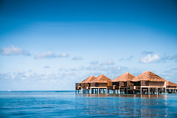 Image showing Over water bungalows with steps into amazing green lagoon