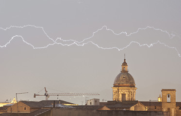 Image showing Parallel lightning over urban houses