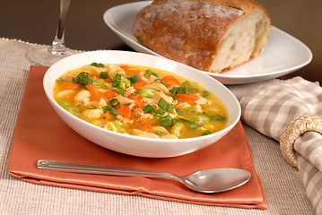 Image showing Bowl of chicken noodle soup with rustic bread