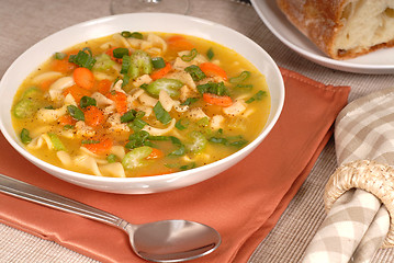 Image showing Closeup of a bowl of chicken noodle soup with rustic bread