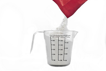 Image showing Pouring flour on Kitchen measuring cup