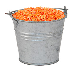 Image showing Red lentils in a miniature metal bucket