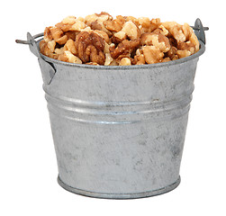 Image showing Chopped walnuts in a miniature metal bucket