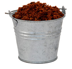 Image showing Dark brown soft / muscovado sugar in a miniature metal bucket