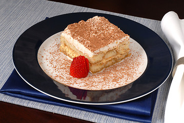 Image showing Tiramisu with sliced strawberry on a blue plate