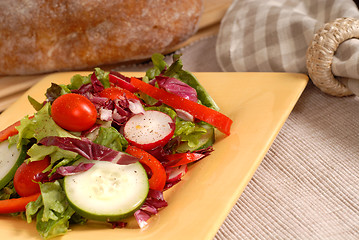 Image showing Crisp salad on a yellow plate with rustic bread