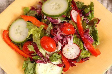 Image showing An overhead view of a crisp healthy salad on a yellow plate