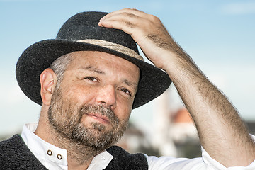 Image showing Man holding his Bavarian black hat