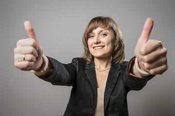 Image showing Young business woman with two thumbs held high