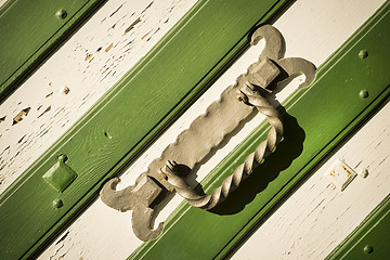 Image showing Metal handle on white green gate