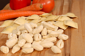 Image showing Gnocchi and ravioli with vegetables in background