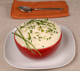 Image showing Mashed potatoes with chives in a red bowl