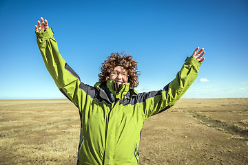 Image showing Happy woman with arms raised