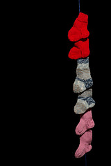 Image showing Line of baby socks on black
