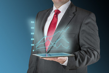 Image showing Business man with tablet und stock chart