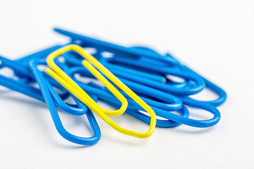 Image showing Yellow paperclip with lots of blue