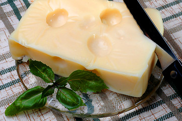 Image showing swiss cheese on plate with knife