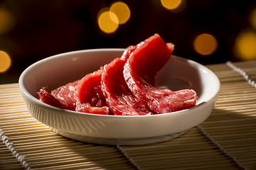 Image showing Sliced raw meat in white bowl