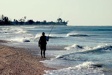 Image showing fisherman on sandy beach