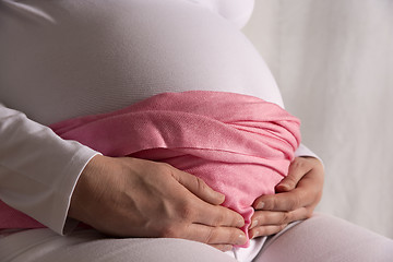 Image showing Pregnant woman is holding her baby bump