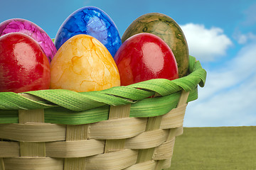 Image showing Colored easter egg basket with blue sky