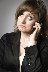 Image showing Business woman wonders on mobile