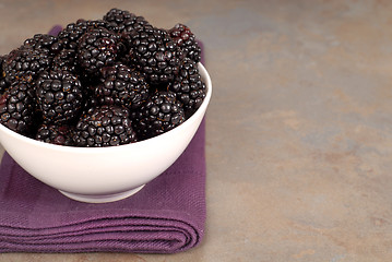 Image showing Blackberries in a white bowl on a purple napkin