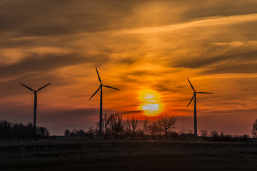 Image showing Three windmills with sunset