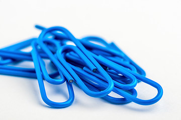 Image showing Blue paperclips on white background