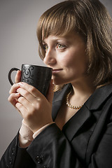 Image showing Woman drinking from a cup