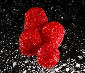 Image showing red raspberries on mirror