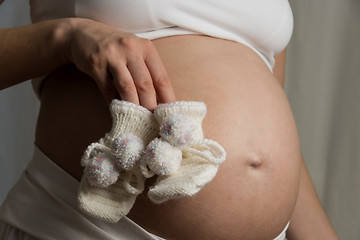 Image showing baby bump with baby shoes