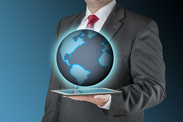 Image showing Business man with tablet and earth