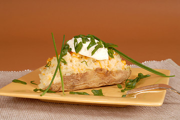 Image showing Twice baked potato with chives and sour cream