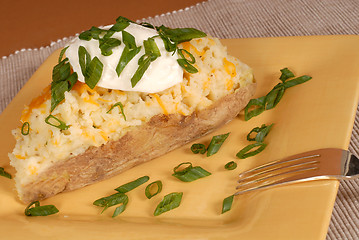 Image showing Twice baked potato with scallions, cheese and sour cream