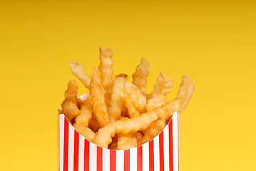 Image showing Box of french fries with yellow background