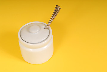 Image showing White sugar bowl on a yellow background