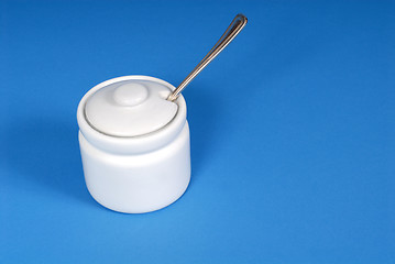 Image showing White sugar bowl on a blue background