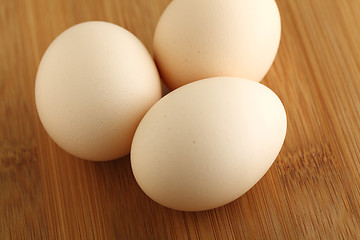 Image showing eggs on wooden background