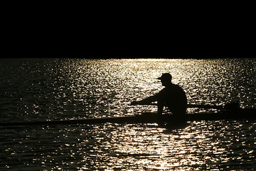 Image showing Rowing alone at sunset