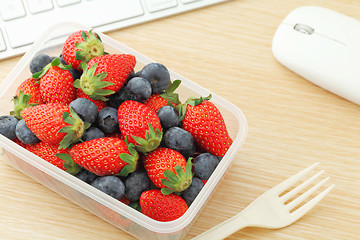 Image showing Health lunch with strawberry and blueberry mix in office