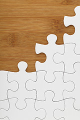 Image showing Puzzle on wooden board